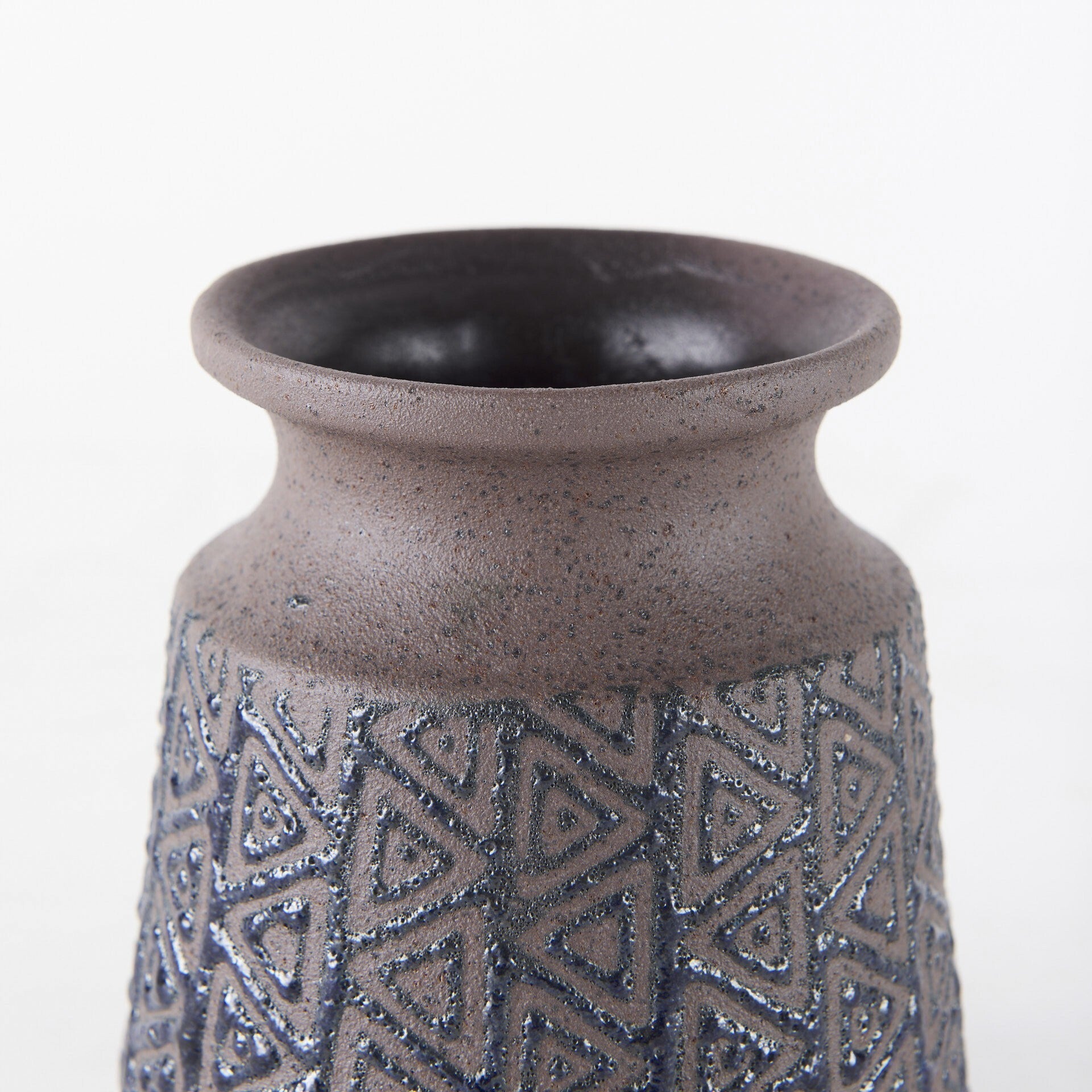 Geometric tribal vase side view displaying speckled brown finish and black embossed pattern
