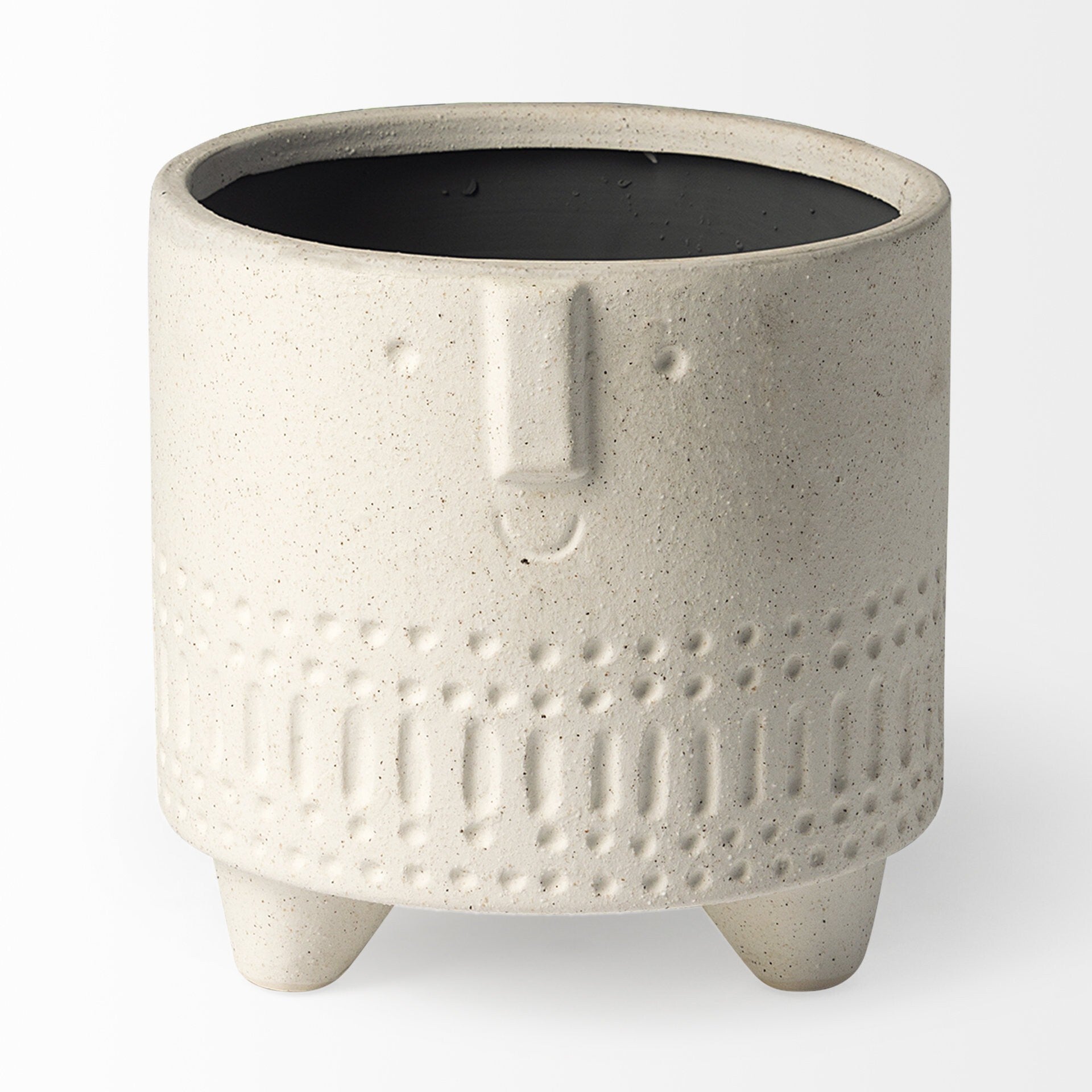 Side view of bohemian vase with four stubby legs and tribal carved patterns, unique ceramic planter for eclectic interiors
