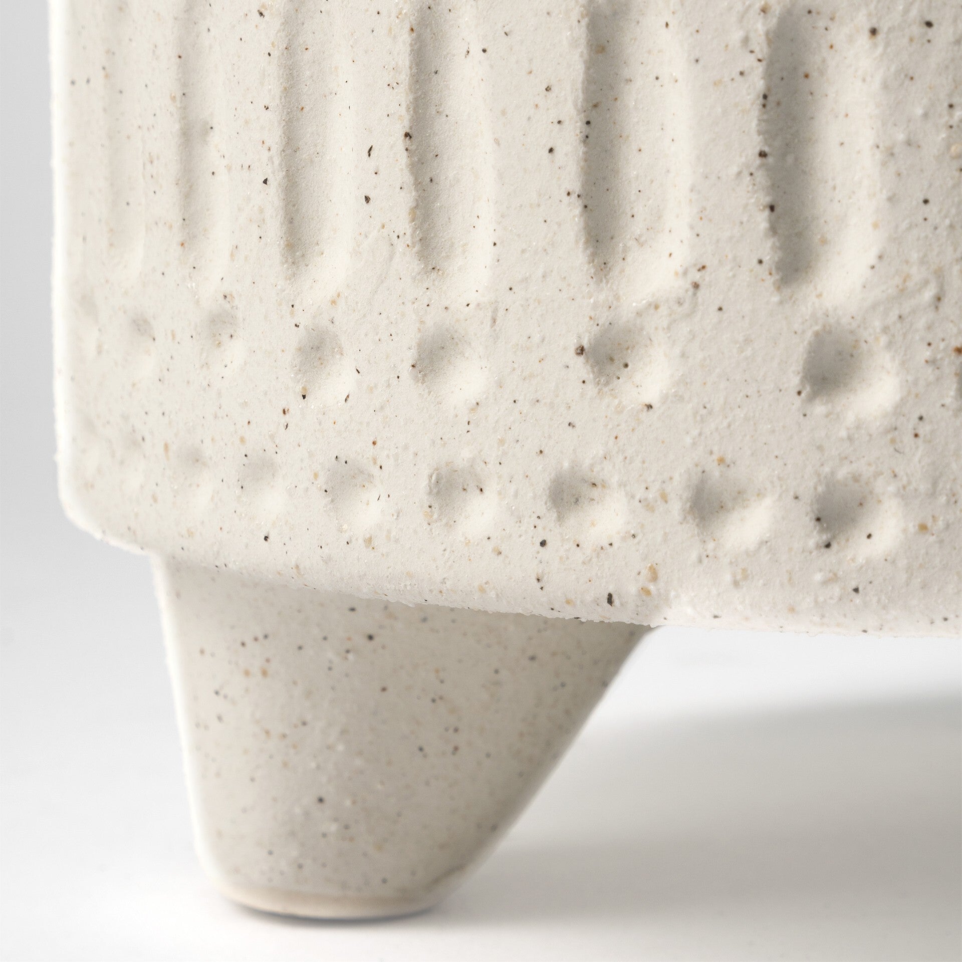 Happy face tribal vase showing textured beige finish and carved details, playful ceramic decor for eclectic home accents

