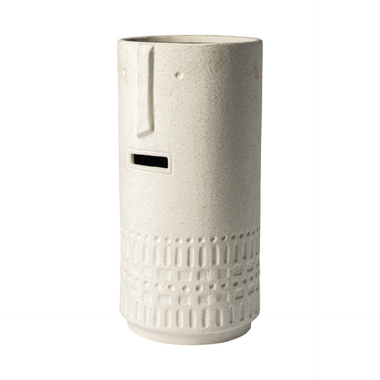 Side view of whimsical tribal vase showing textured beige finish and carved pattern details
