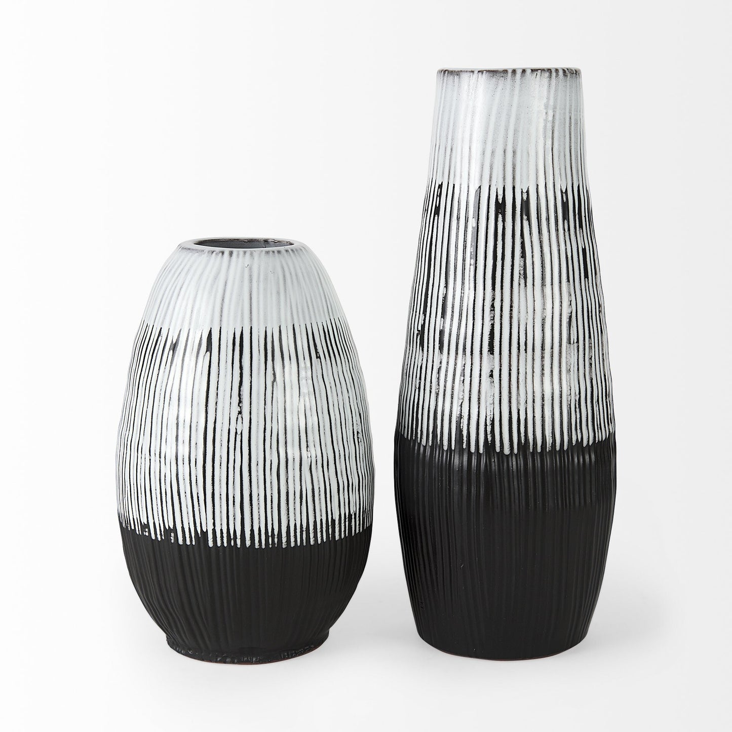 Side angle of 19-inch patterned ceramic vase displaying graceful pod silhouette with full middle body and sophisticated two-tone black and white glaze finish
