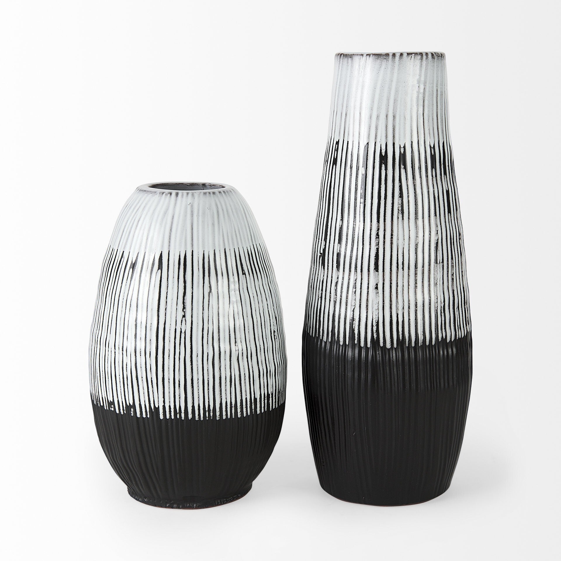 Side angle of 19-inch patterned ceramic vase displaying graceful pod silhouette with full middle body and sophisticated two-tone black and white glaze finish
