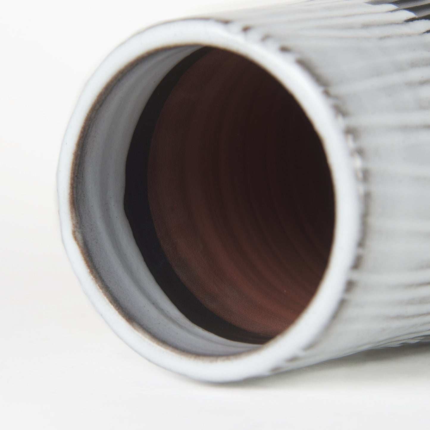 Profile view of 19-inch pod-shaped ceramic vase showcasing narrow top opening and full body design with striking black and white color contrast
