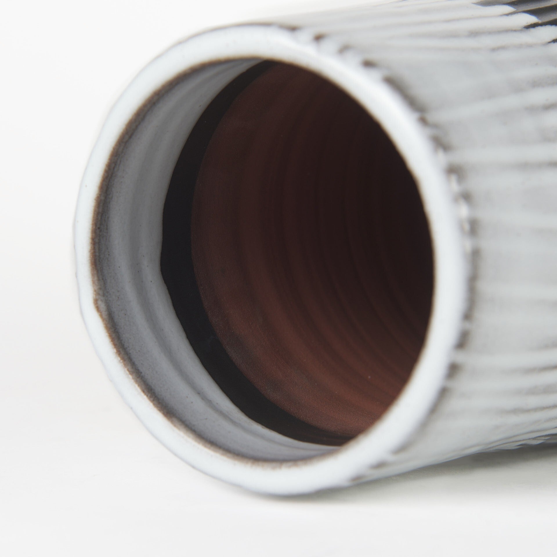 Profile view of 19-inch pod-shaped ceramic vase showcasing narrow top opening and full body design with striking black and white color contrast
