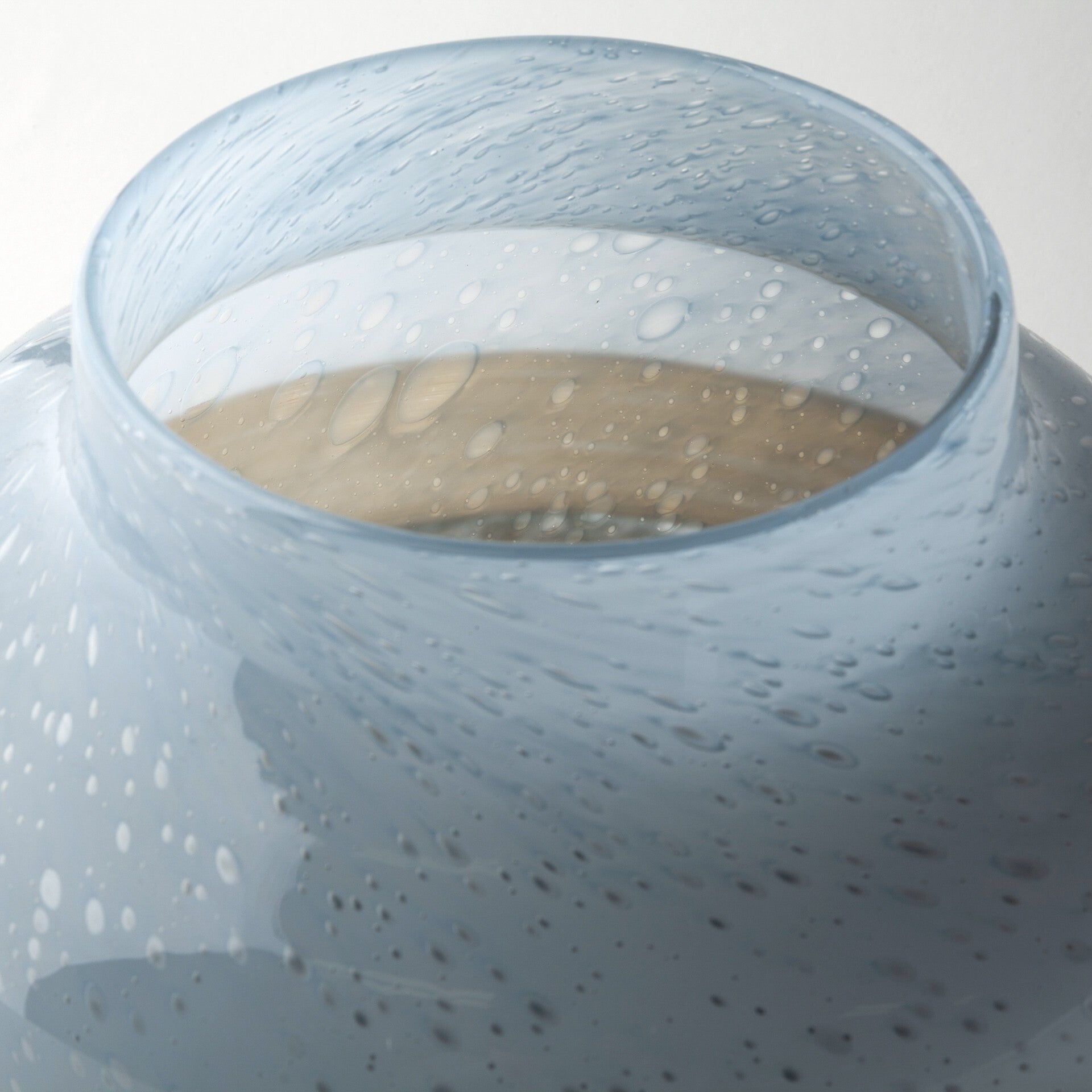 Coastal bubble glass vase alternative angle showing one-of-a-kind blue brown ocean pattern
