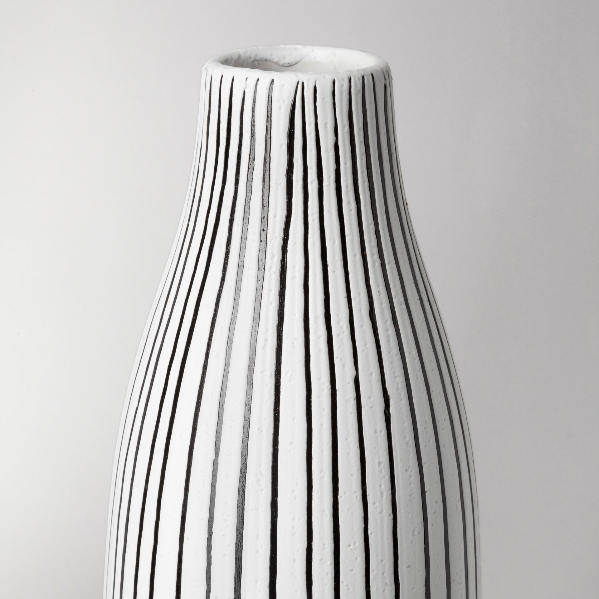 Black and white pinstripe vase detail showing premium ceramic construction and contemporary design

