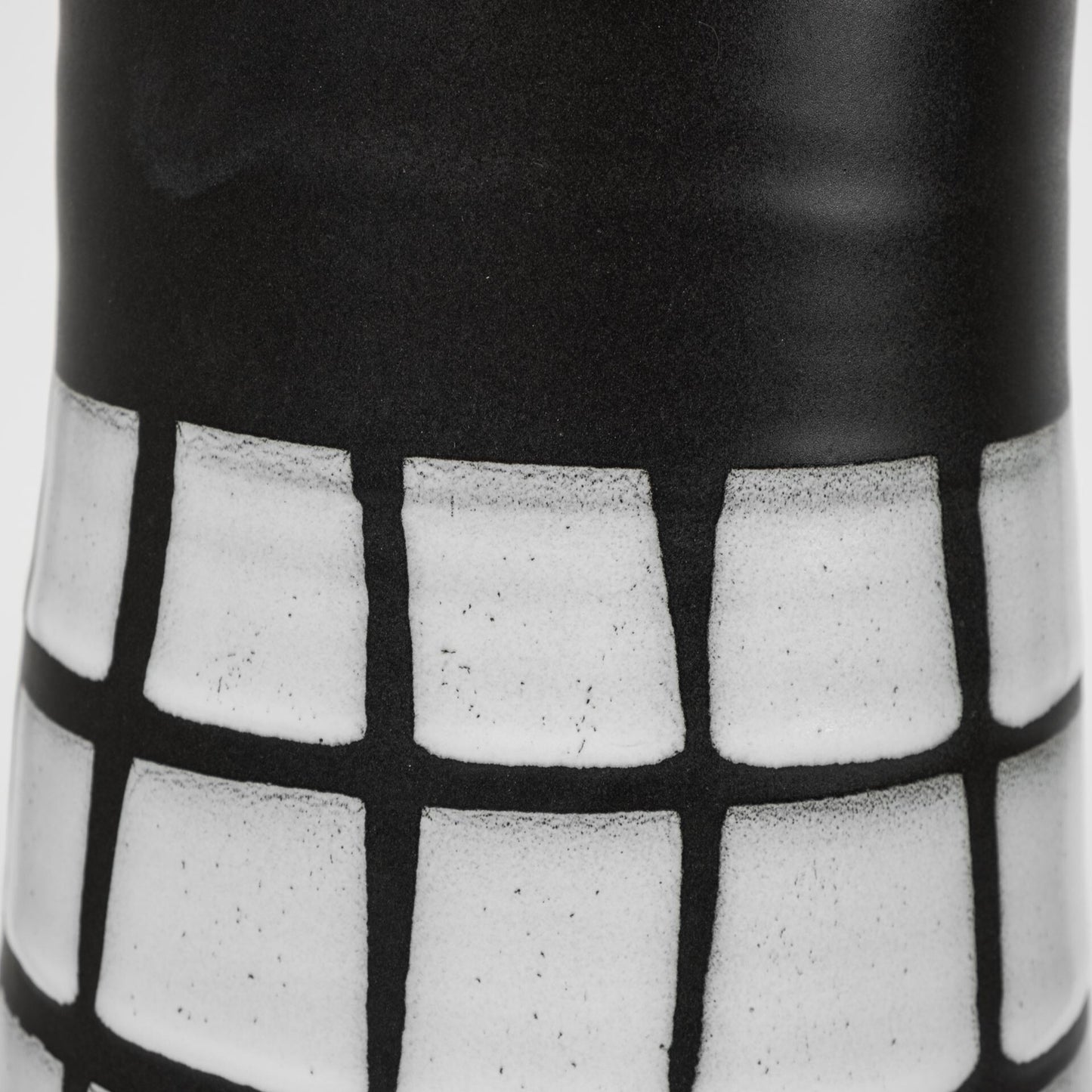 Top angle view of large black and white vase showing geometric grid pattern and contemporary minimalist design aesthetic
