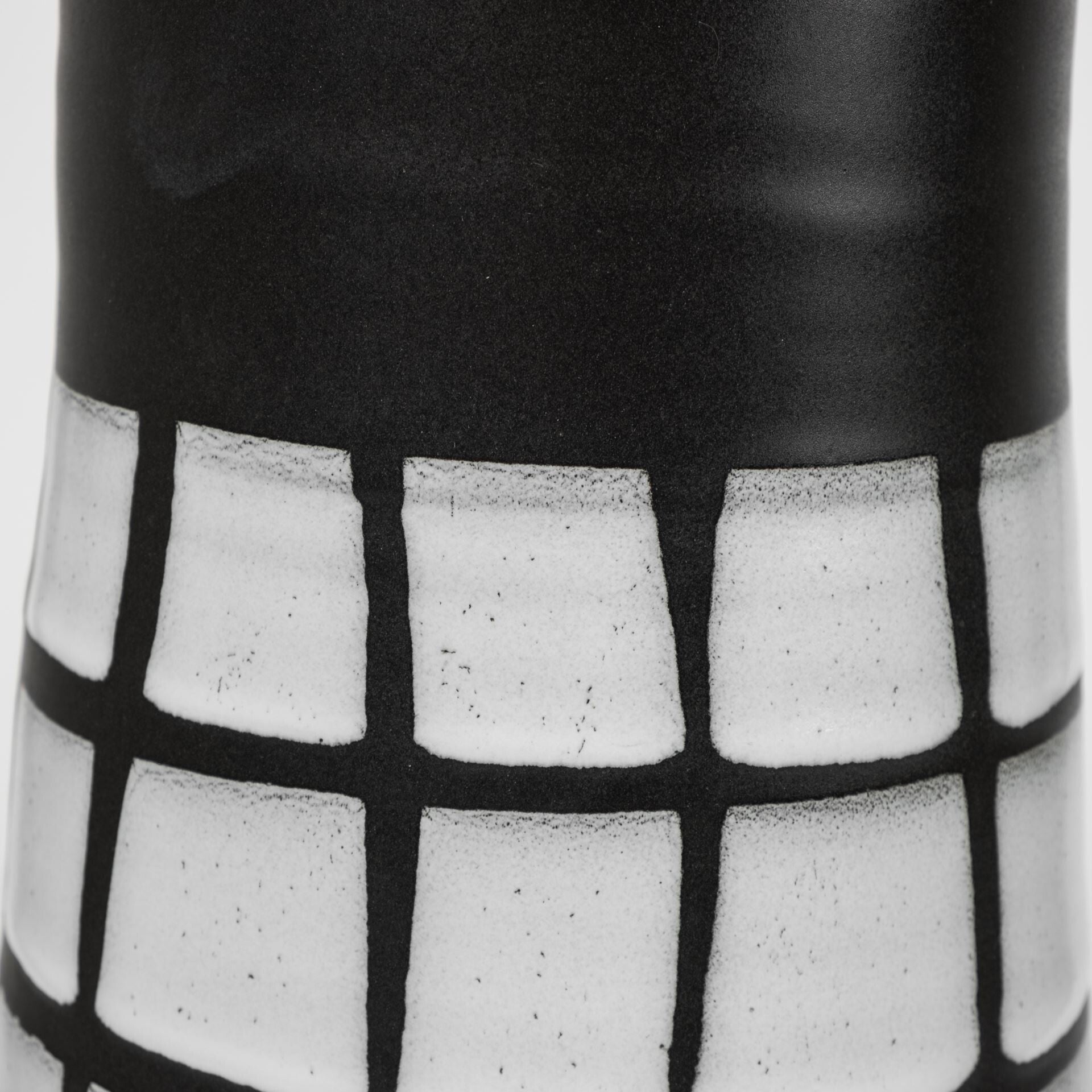 Top angle view of large black and white vase showing geometric grid pattern and contemporary minimalist design aesthetic
