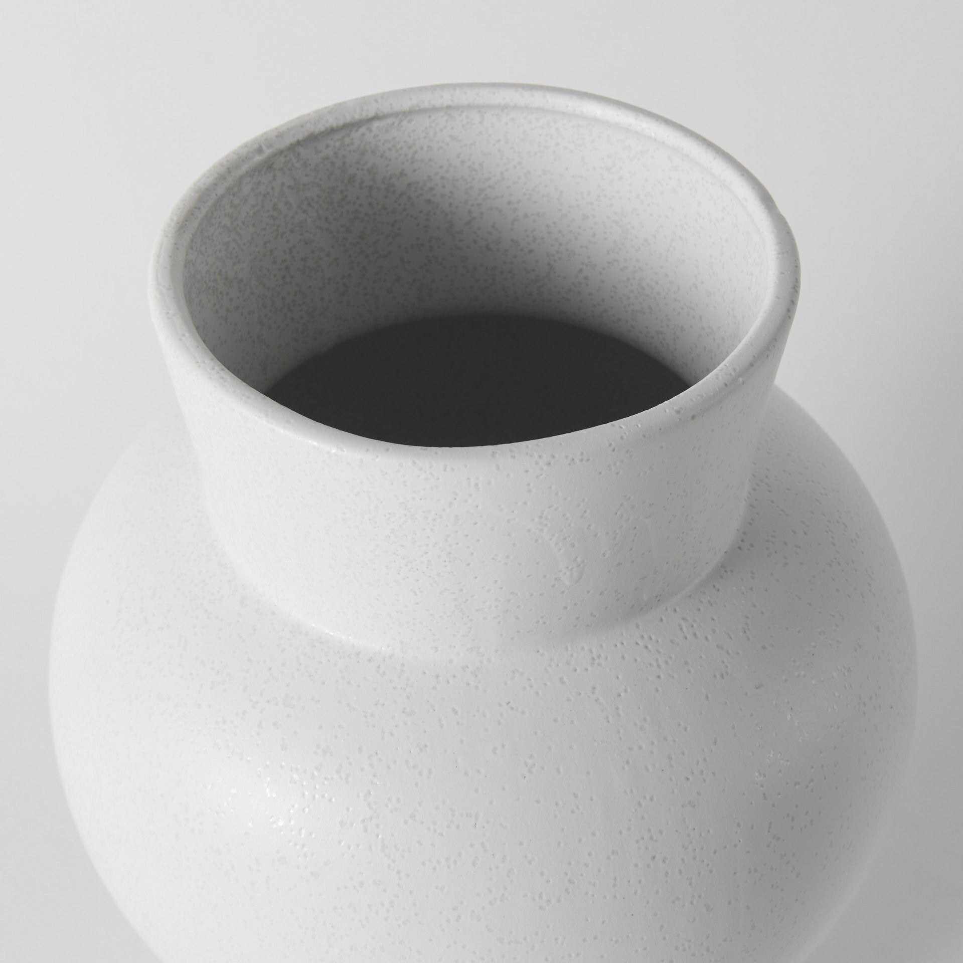 Top view of contemporary white vase revealing conical opening and geometric design, perfect for fresh flowers or dried botanical arrangements
