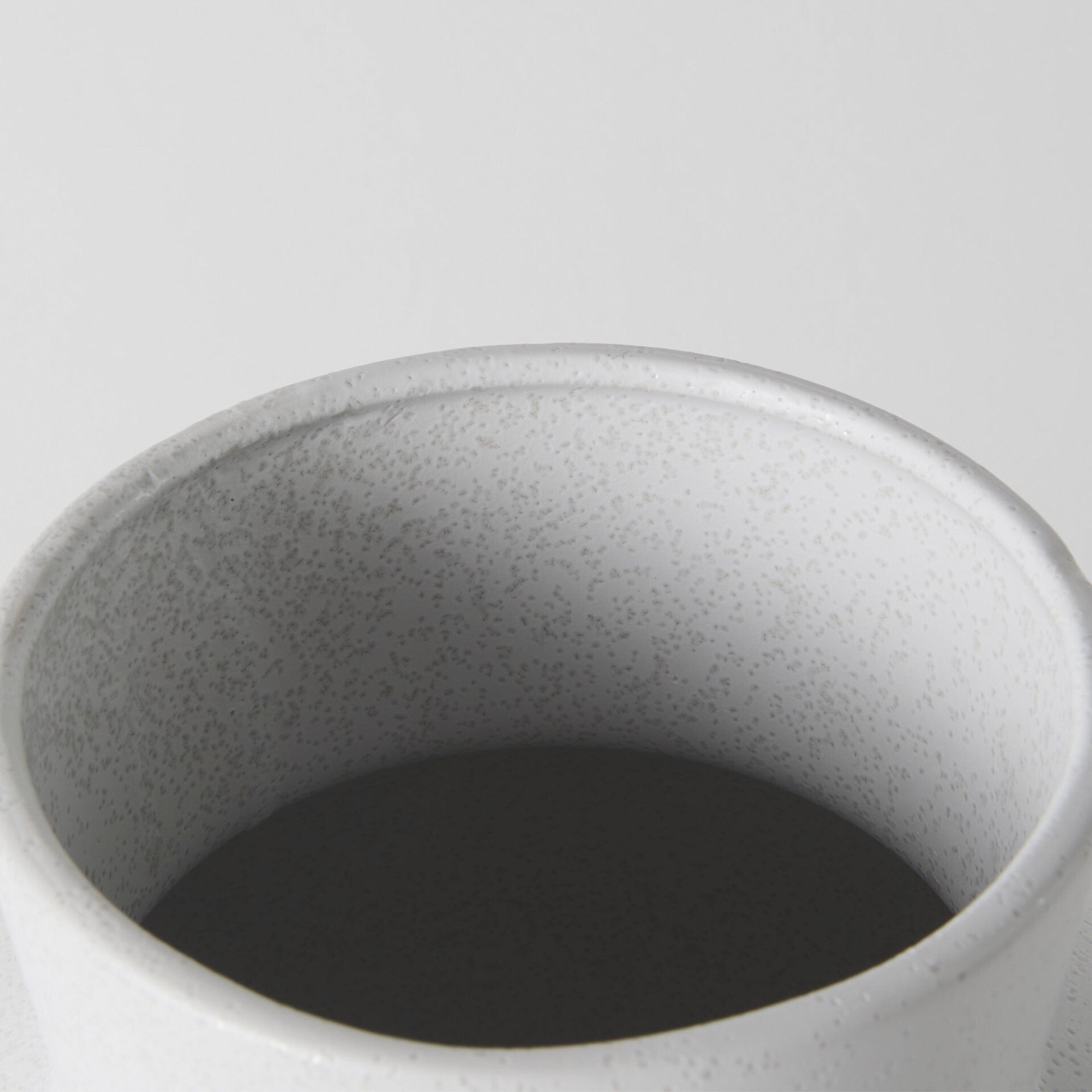 Three-quarter view of 11-inch white ceramic vase emphasizing unique architectural form and elegant proportions, ideal for modern minimalist decor
