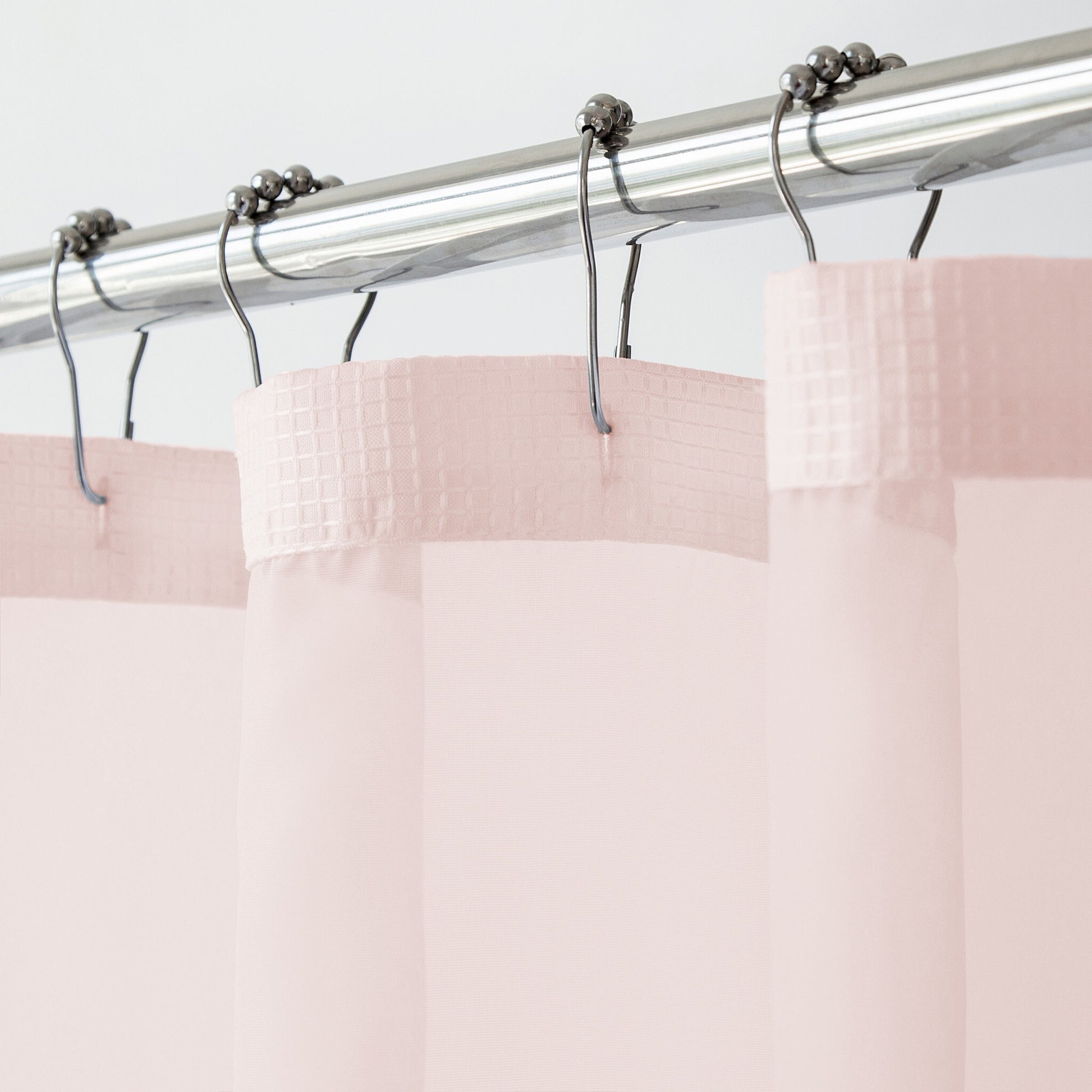 Blush pink shower curtain set with snap-off liner displayed in elegant bathroom setting
