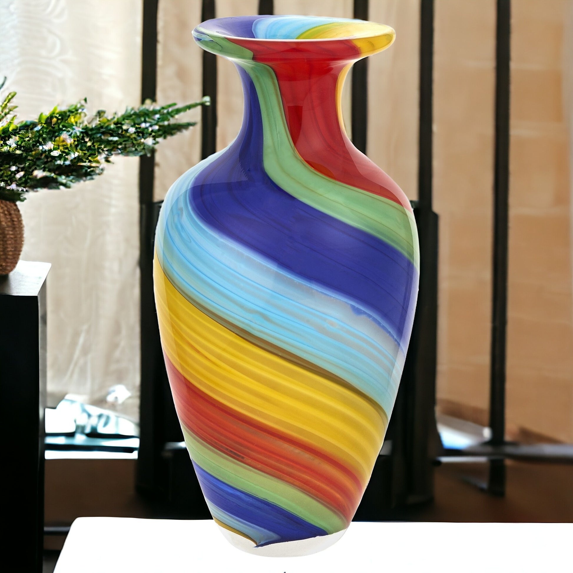 Abstract Murano glass vase close-up displaying colorful red yellow blue green pattern and unique sculptural shape
