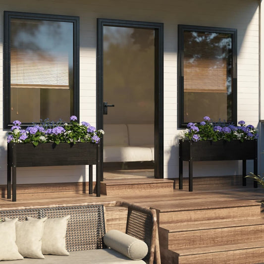 Set of 2 black pinewood planters in outdoor garden setting