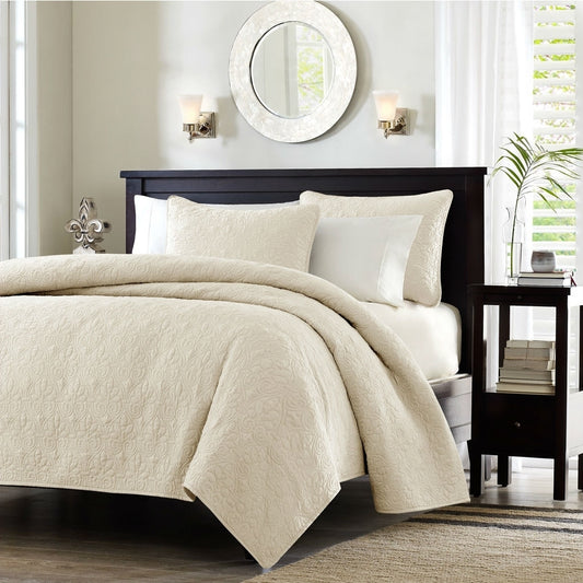 Close-up detail of ivory beige quilted coverlet showing elegant stitching pattern, neutral luxury bedding for master bedroom decor