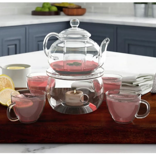 Glass teapot with infuser and warmer showing tea brewing process and steam
