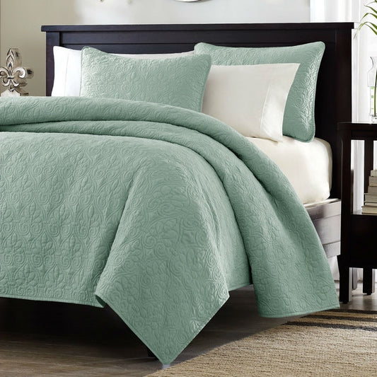 King size seafoam blue quilted coverlet set with floral pattern on modern bed