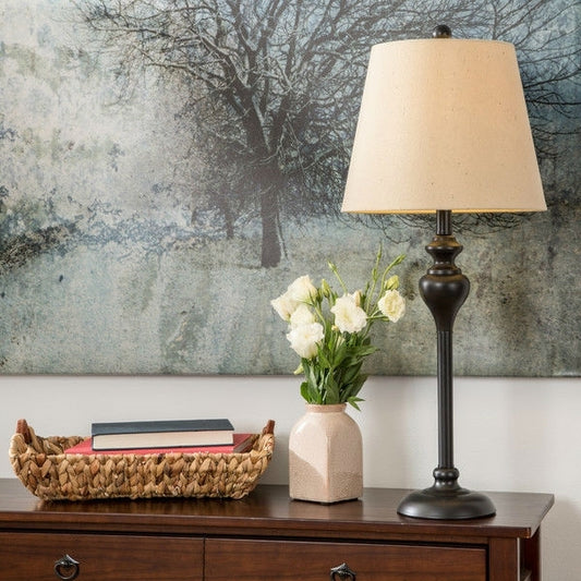 Close-up of elegant black floor lamp with light gold drum shade showing sophisticated design details and premium construction quality
